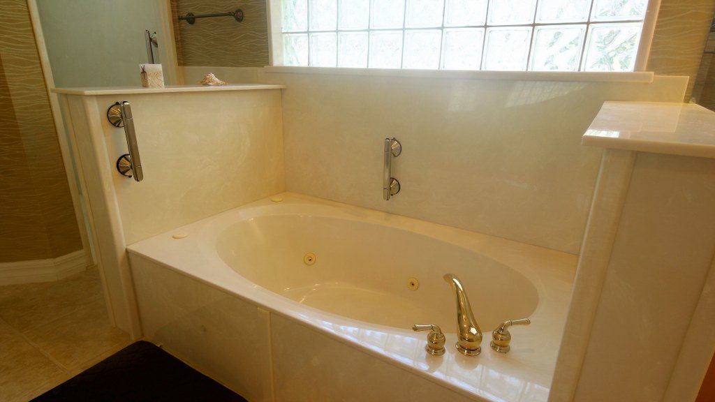 Bathroom with grab bars beside the tub and shower