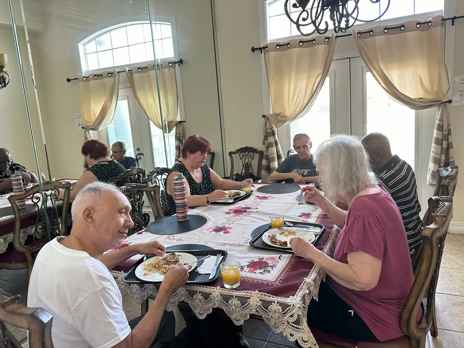 Residents sharing a meal around the dining table